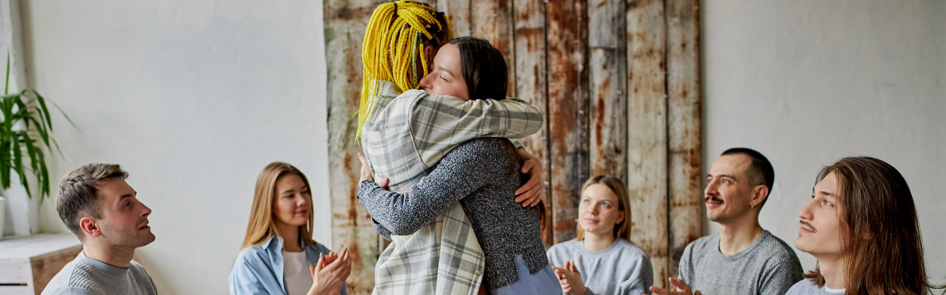 two women hugging infront of everybody